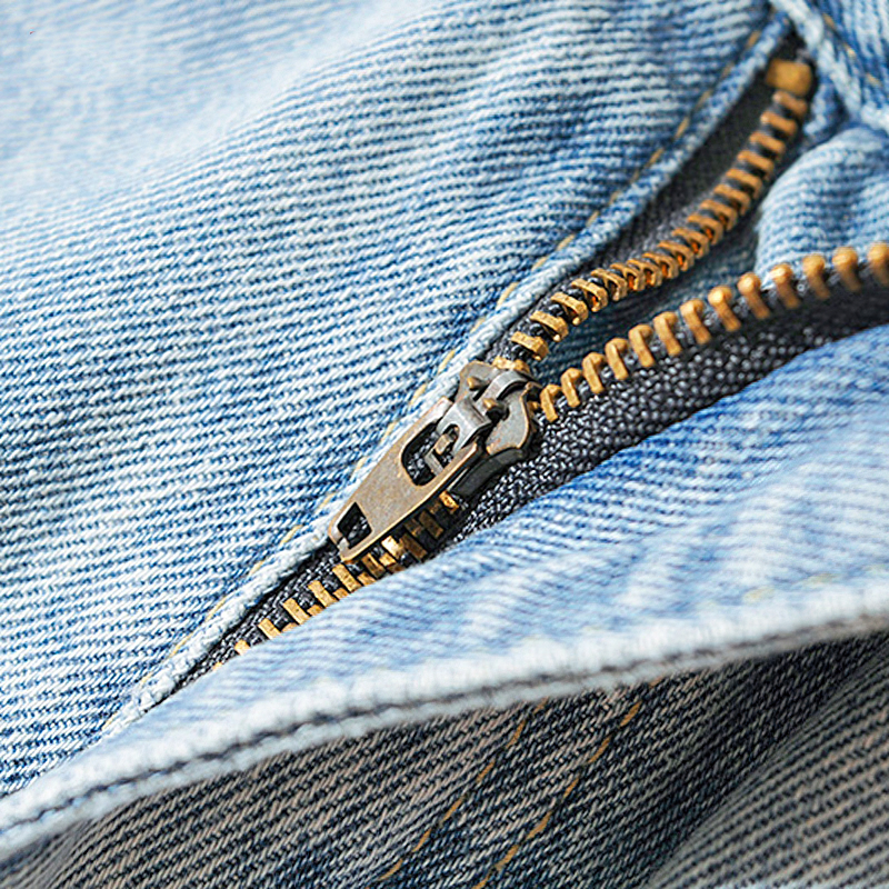 Close-up of zipper detail on cool women's long loose denim jeans with pockets, showcasing high-quality craftsmanship.