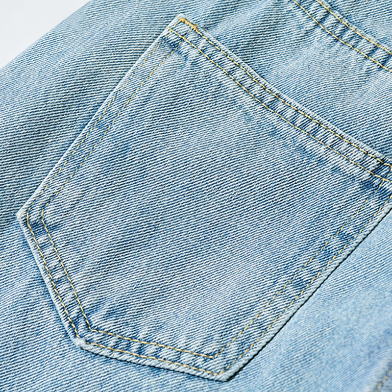 Close-up of a stylish pocket on trendy women's long loose jeans, showcasing the cool denim fabric and stitch details.