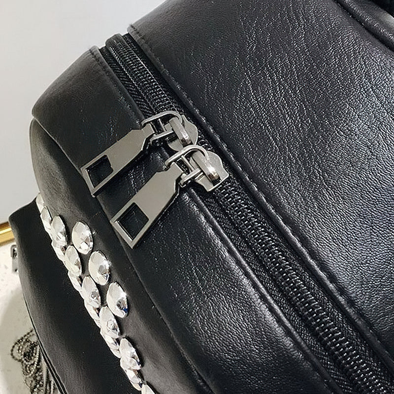 Close-up of stylish black mini backpack zipper with rivet decoration, perfect for casual outfits.