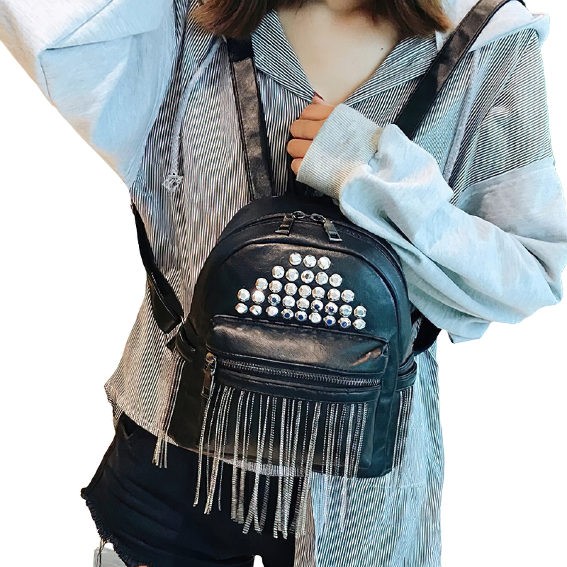 Mini black backpack with rivets and fringes, perfect for stylish casual outfits and everyday use.