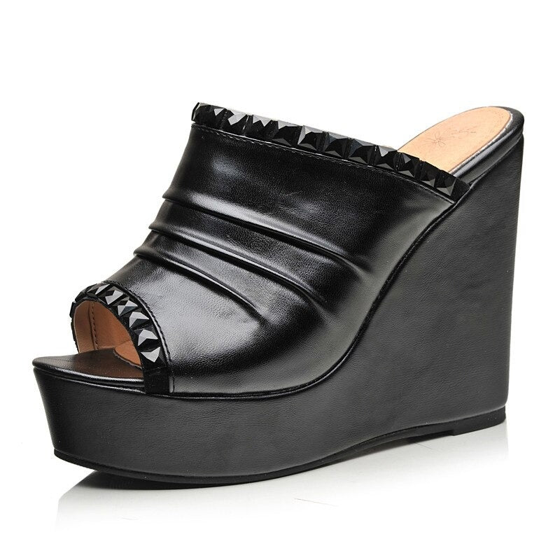 Black open toe wedge sandals with studded detailing, perfect for a chic summer look.