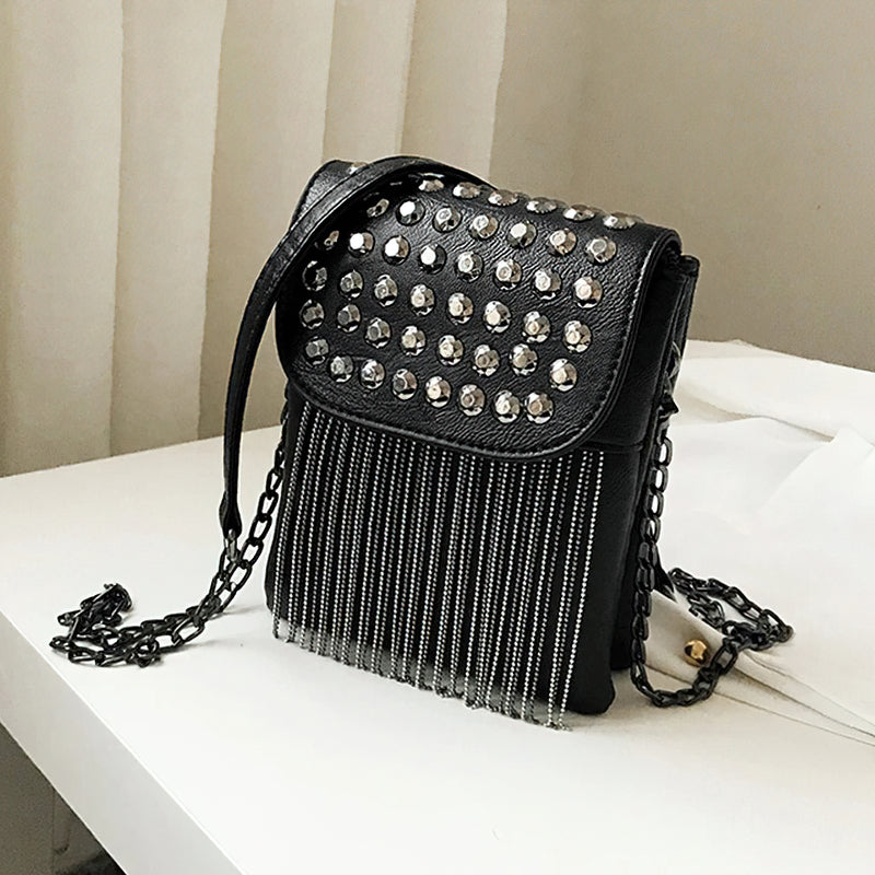 Black women's shoulder bag with decorative chain, fringe, and diamond accents, perfect for trendy fashion statements.