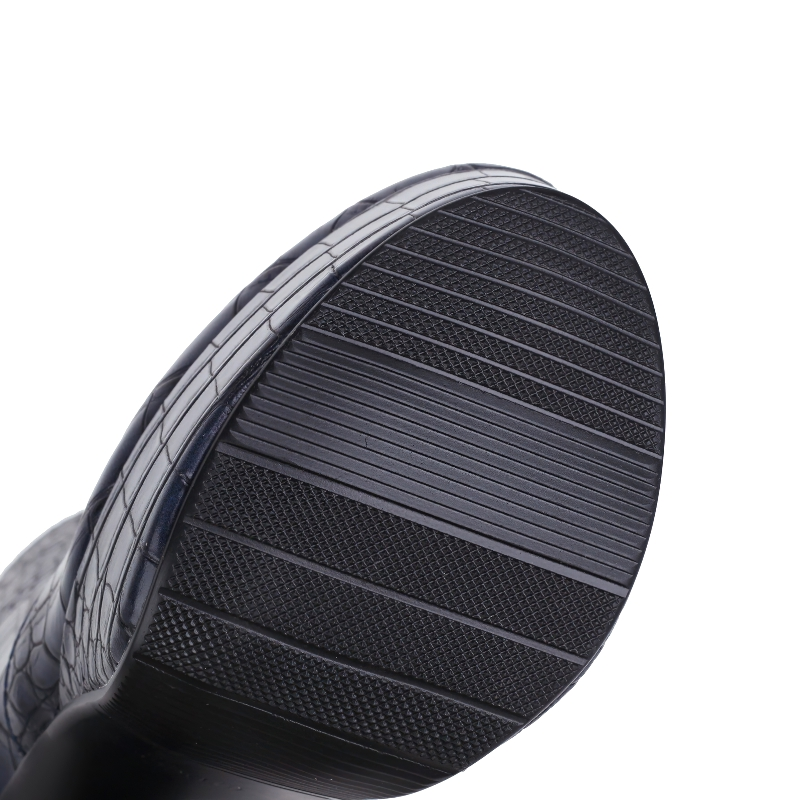 Close-up of the sole of women's square high heel shoes with trendy crocodile print design.