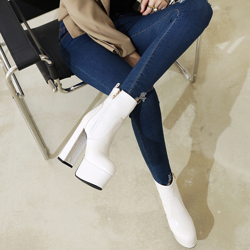 Stylish women's square high heel shoes in white crocodile print, paired with denim jeans, perfect for a trendy look.