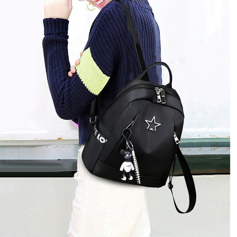 Stylish women's black PU leather backpack with star detail, perfect for casual travel and daily use.