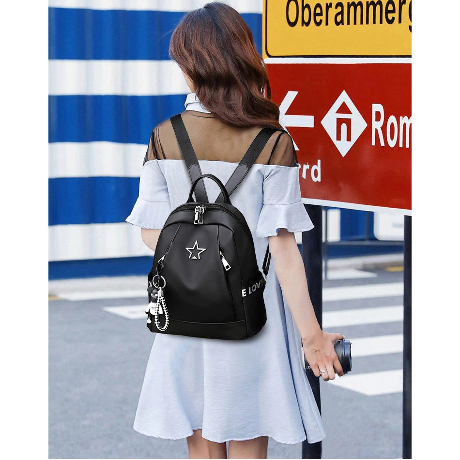 Trendy women's black PU leather backpack worn casually, showcasing its stylish design and practical features.