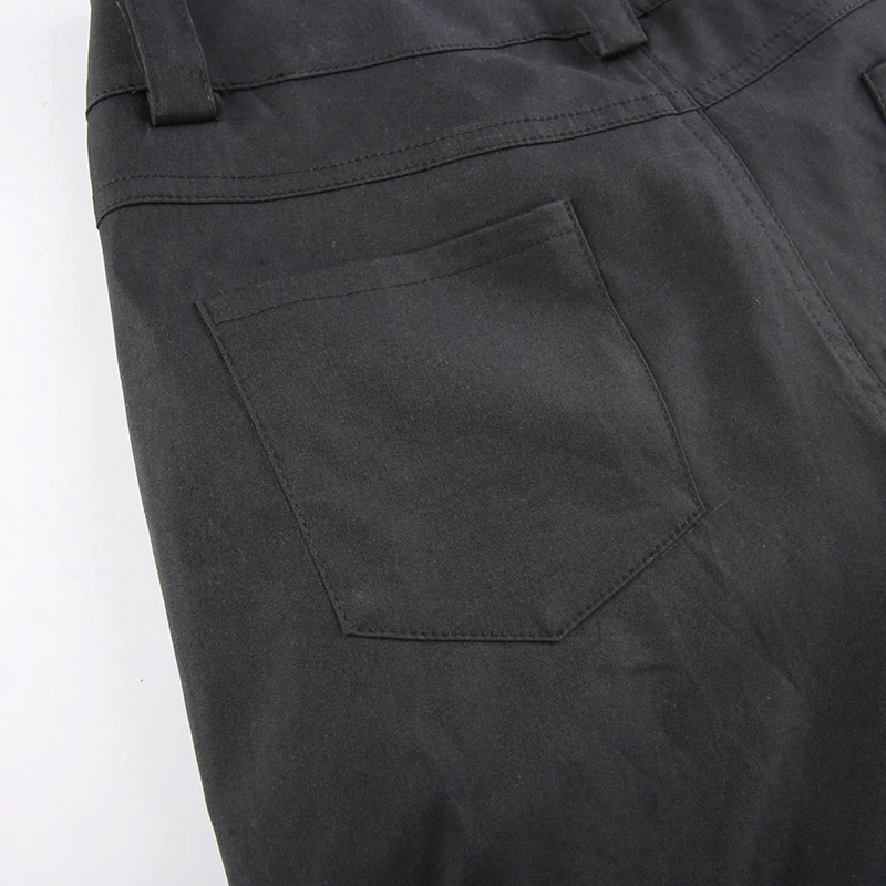 Close-up of the back pocket of black women's wide-leg cargo pants in punk style.