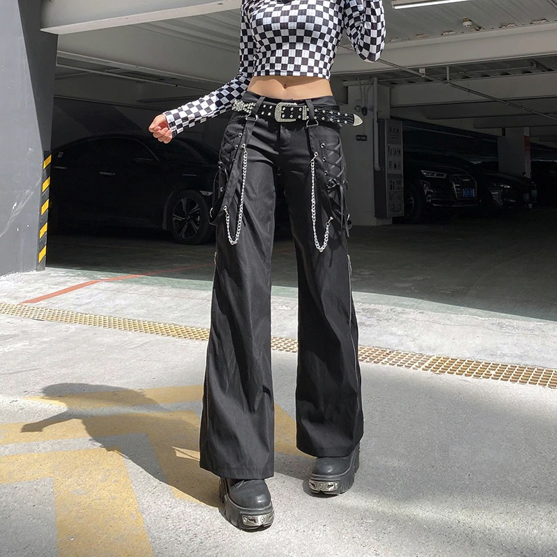 Fashion women's wide leg cargo pants in punk style with chains, paired with a striped crop top.