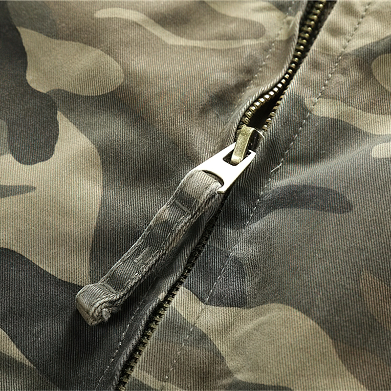 Close-up of the stylish zipper on a camo denim jacket, showcasing its unique military-inspired design.