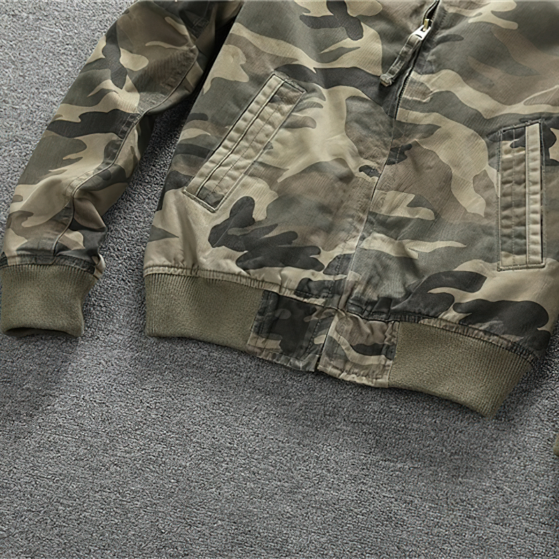 Stylish men's camouflage zip-up denim jacket on a gray background, perfect for casual military-inspired looks.