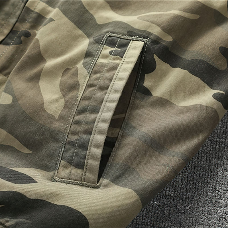 Close-up of stylish camouflage print fabric on a men's military-style jacket pocket.