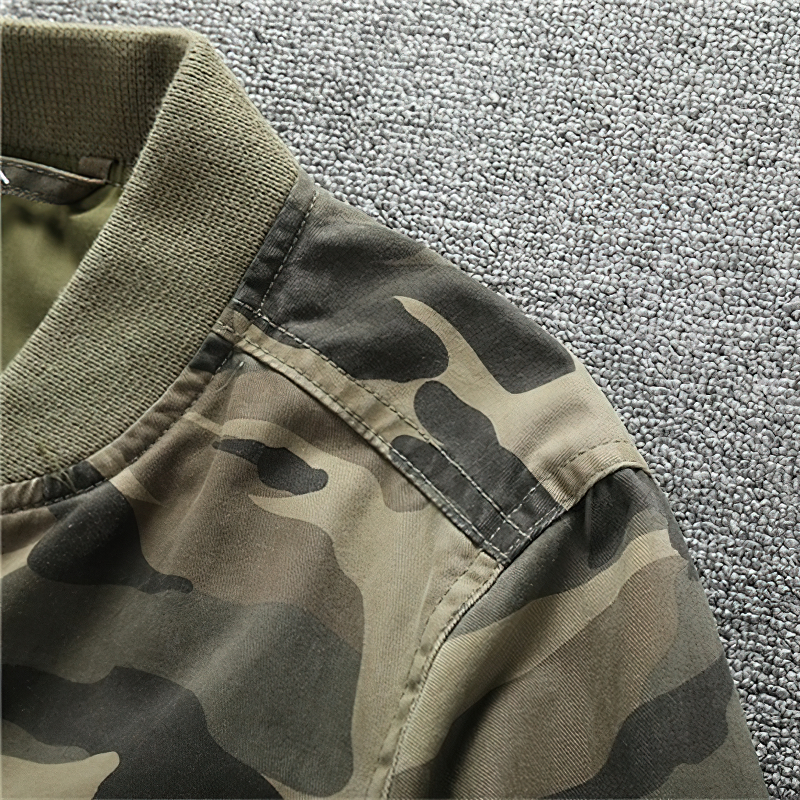 Close-up of stylish camouflage print on a men's zip-up denim jacket, showcasing trendy military design details.