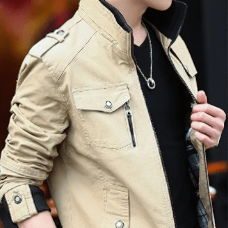 Stylish male wearing a beige military zipper jacket with pockets and a stand collar, perfect for casual wear.