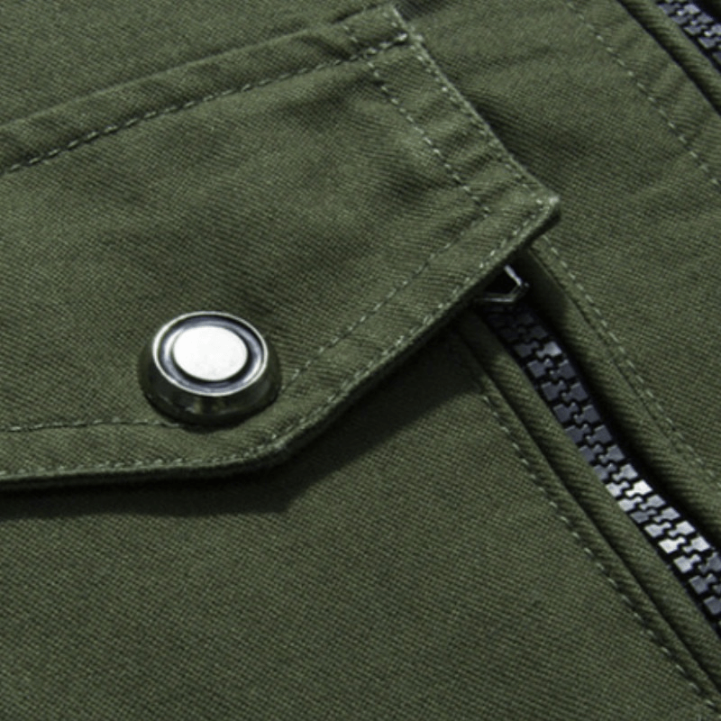 Close-up of military style green zipper jacket showcasing pocket detail and fabric texture.