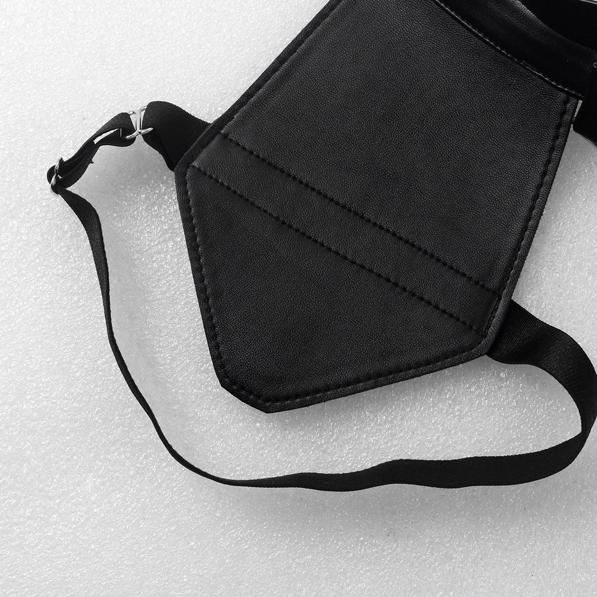 Close-up of a sleek black faux leather body chest harness with adjustable straps for a perfect fit.