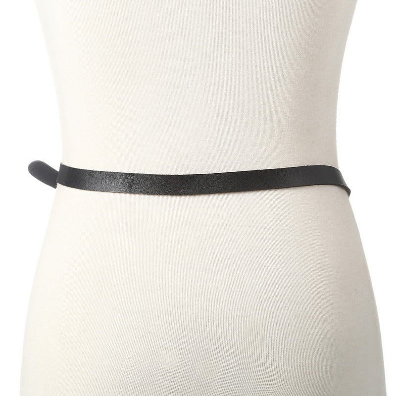 Faux leather body harness belt for women displayed on mannequin, showcasing sleek style and minimalist design.