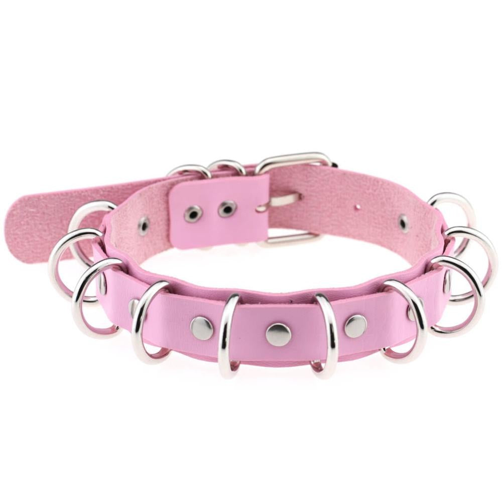 Pink faux leather choker with metal rings, perfect for goth and punk fashion accessories.