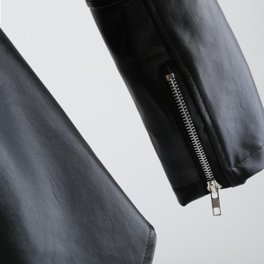Close-up of a women's black faux leather motorcycle jacket showcasing stylish zippers and vintage design details.