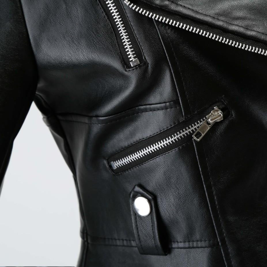 Close-up of women's black faux leather motorcycle jacket, featuring stylish zippers and rivet details.
