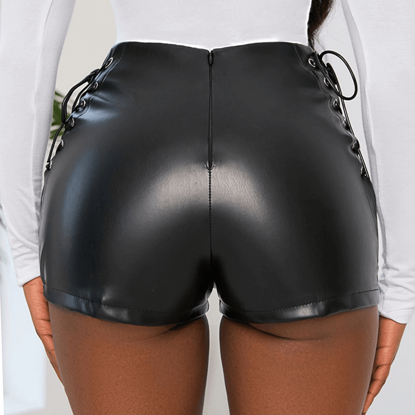 Back view of women's high waist faux leather shorts with lace-up details in black.