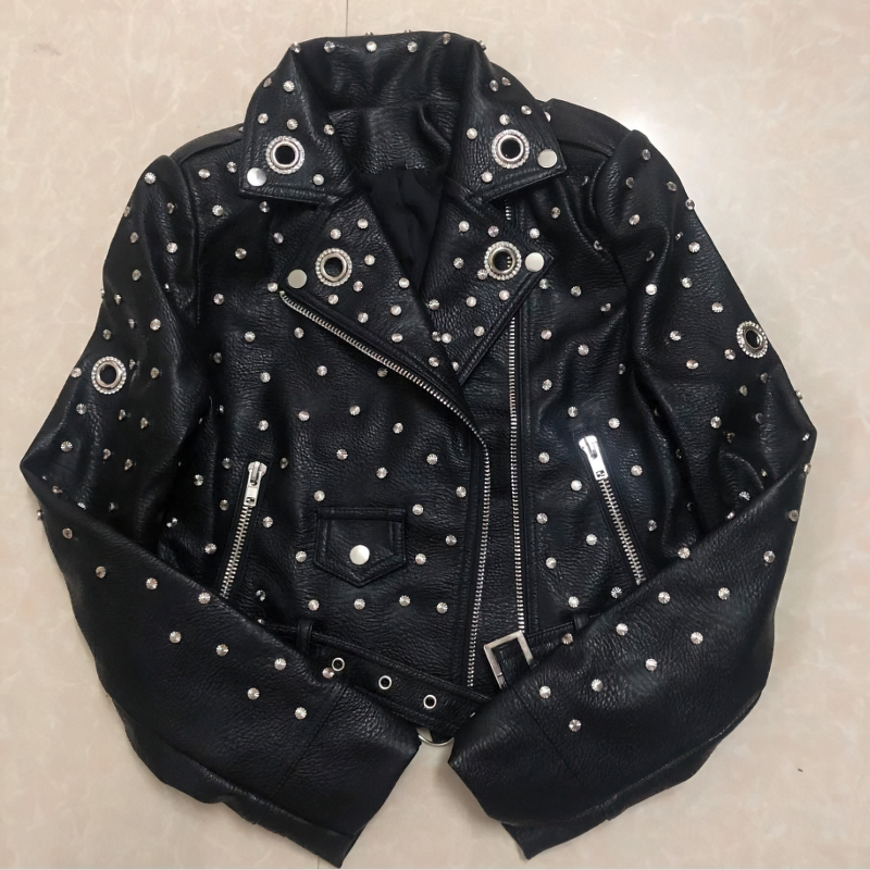 Faux leather women's rock style jacket adorned with stylish silver rivets for a bold, alternative fashion statement.