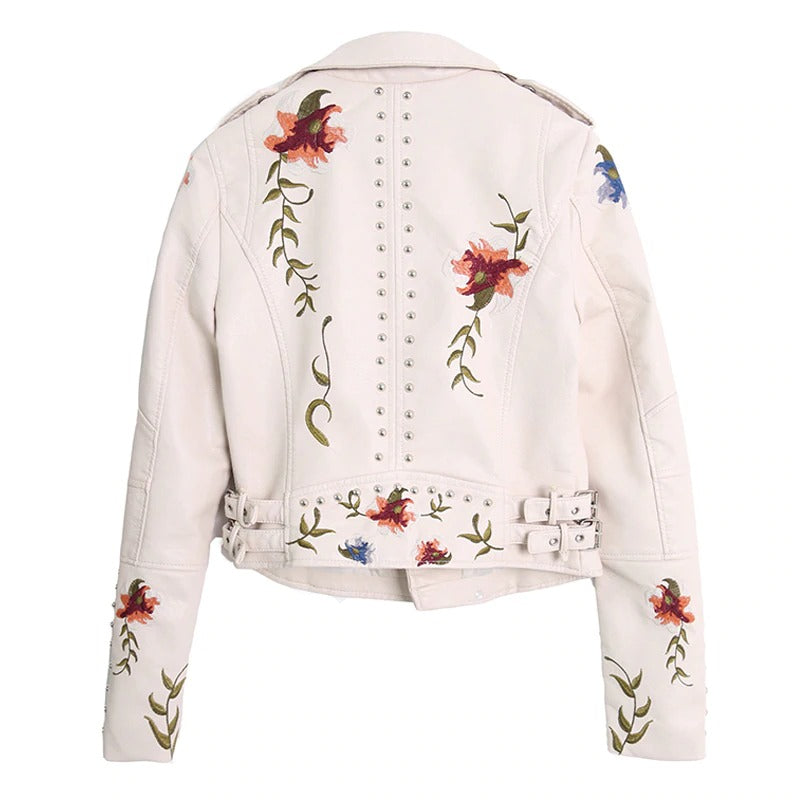 Stylish white faux leather women's motorcycle jacket with floral embroidery and studded details.