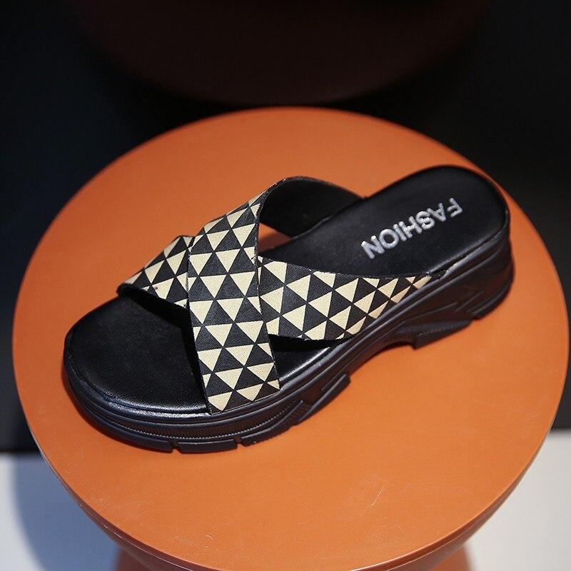 Stylish alternative female sandals with geometric pattern on a round pedestal.