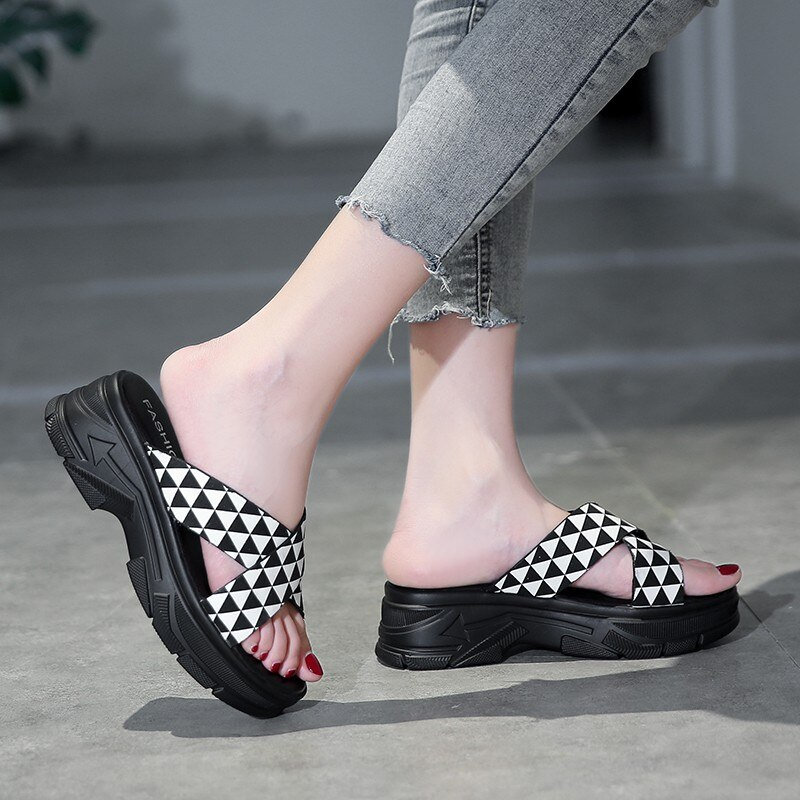 Stylish black and white alternative style sandals on a model's feet, perfect for aesthetic summer outfits.