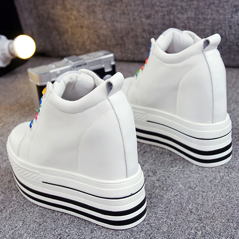 Stylish female canvas platform sneakers in white with colorful laces, perfect for any outfit.