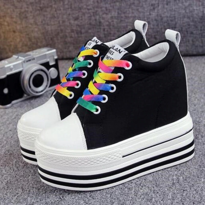Colorful female canvas platform sneakers with rainbow laces and striped sole, perfect for any stylish outfit.