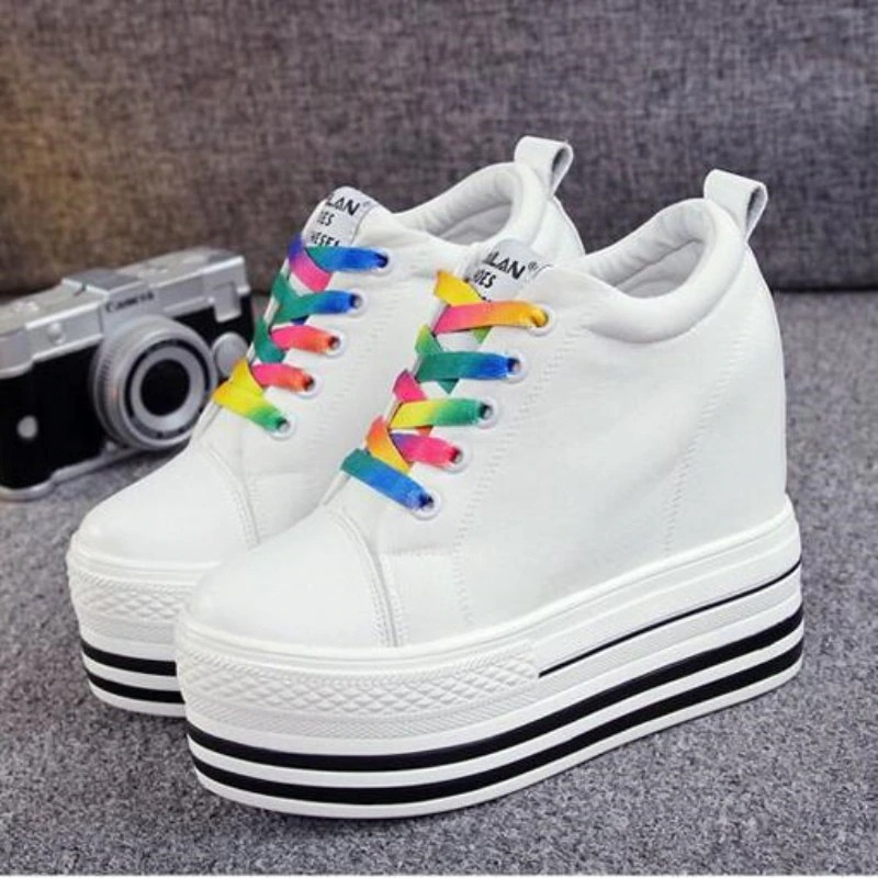 Stylish women's white canvas platform sneakers with colorful laces, perfect for any outfit and height boost.