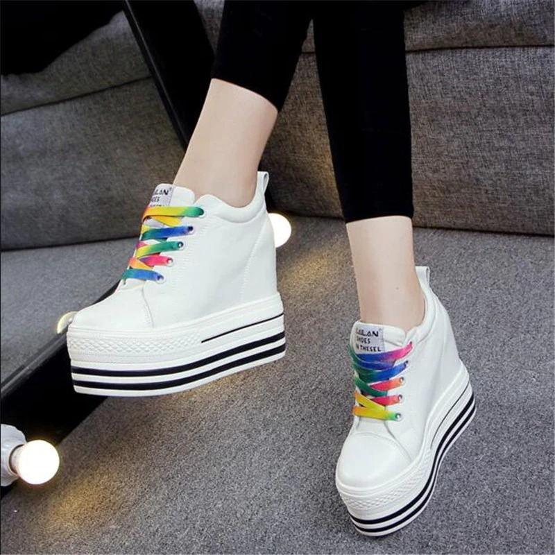White canvas platform sneakers with colorful laces, perfect for stylish women's outfits.