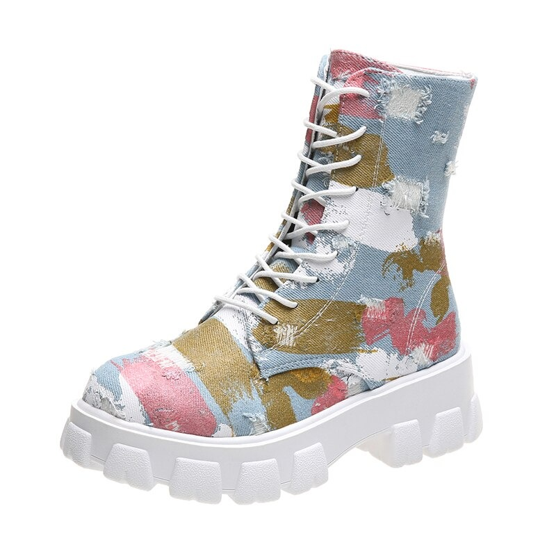 Stylish female combat boots in colorful alternative style with chunky sole and lace-up design.