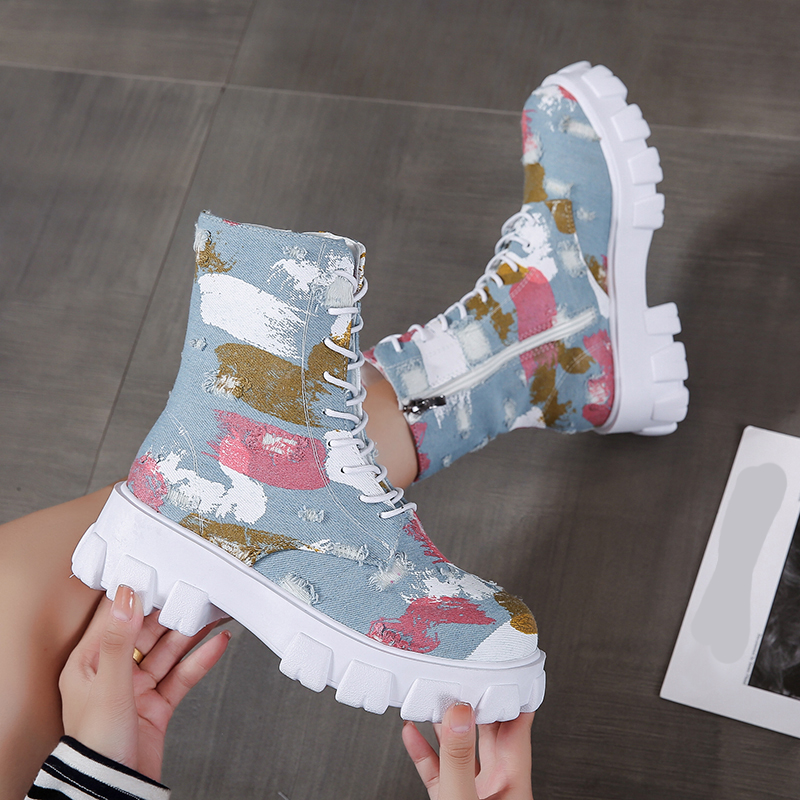 Stylish female combat boots in alternative style with trendy print and white soles, perfect for rocker girl outfits.
