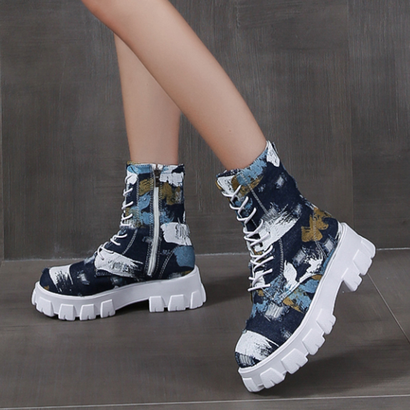 Stylish female combat boots in alternative style with trendy print and side zipper for a edgy rocker girl outfit.