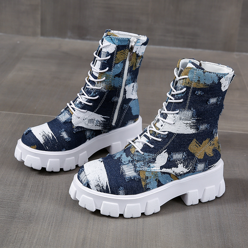Women's alternative style combat boots with trendy blue print and chunky white sole, perfect for rocker girl outfits.