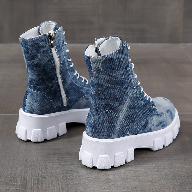Women's blue denim combat boots with laces and zipper, trendy alternative style sneakers for a rocker girl outfit.