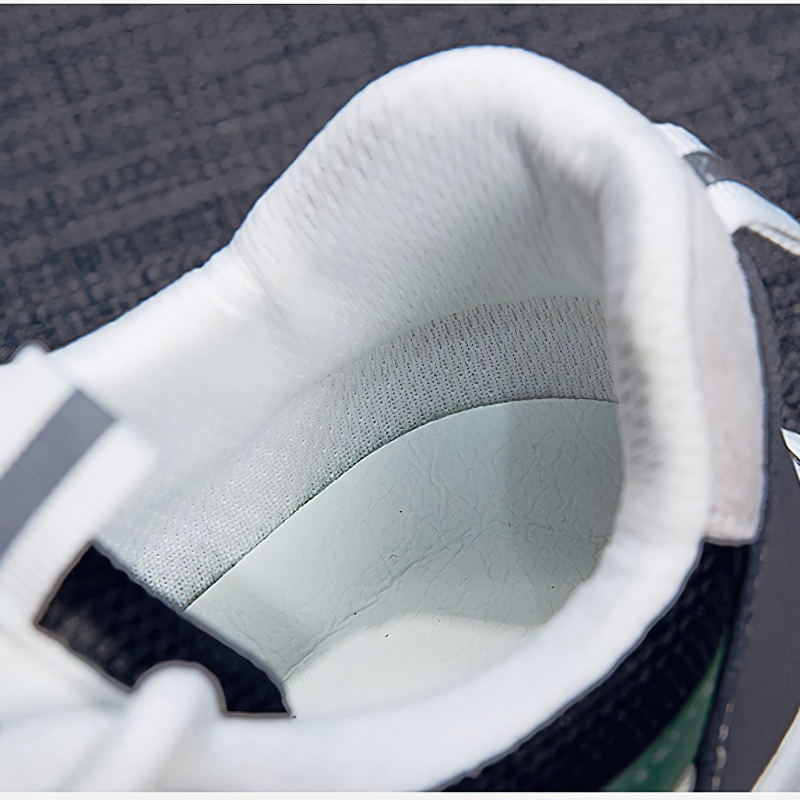 Close-up of the interior of female lace up sneakers, showcasing soft padding and stylish design.