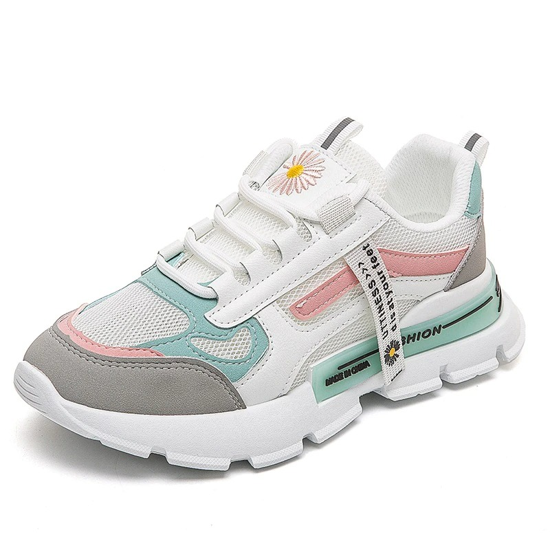 Chic female lace up sneakers in white with pink and mint accents, featuring a daisy design and thick sole.