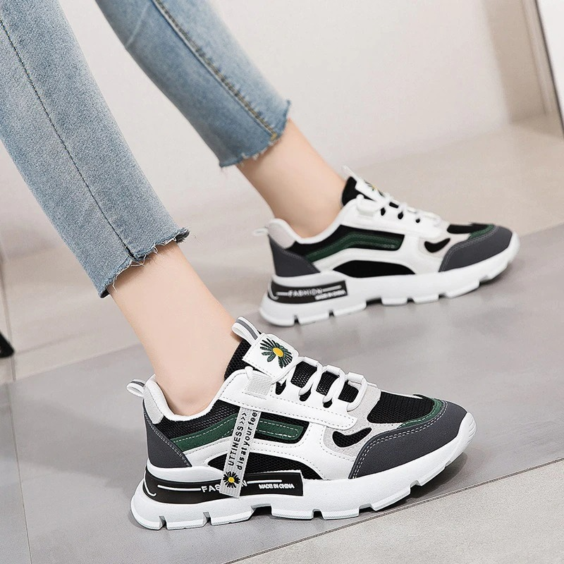 Stylish female lace up sneakers in black and green, perfect casual sports shoes for women with a thick bottom.