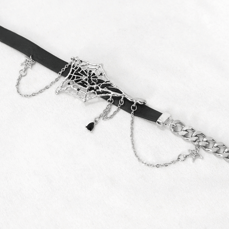 Asymmetrical black leather choker featuring a spider web design and silver chain accents for a gothic look.