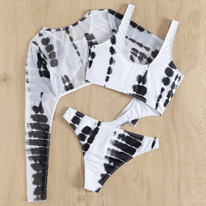 Stylish female monokini swimsuit with long sleeves and high cut, featuring a trendy black and white tie-dye pattern.