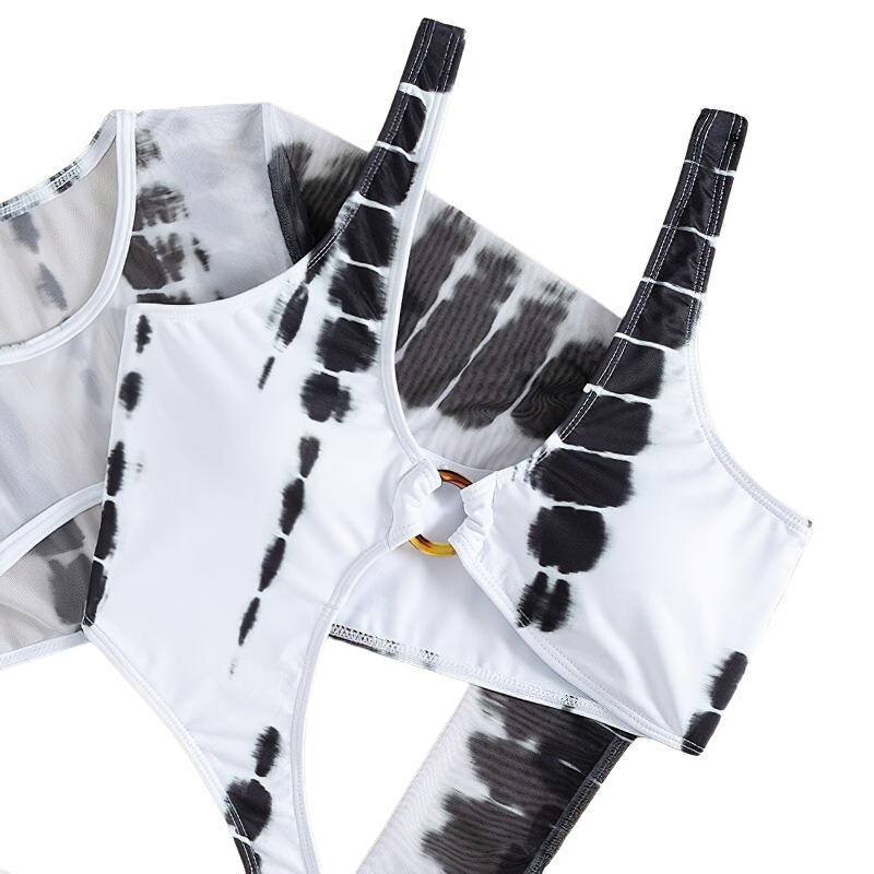 Stylish women's bikini top in white and black tie-dye pattern with ring detail and adjustable straps.