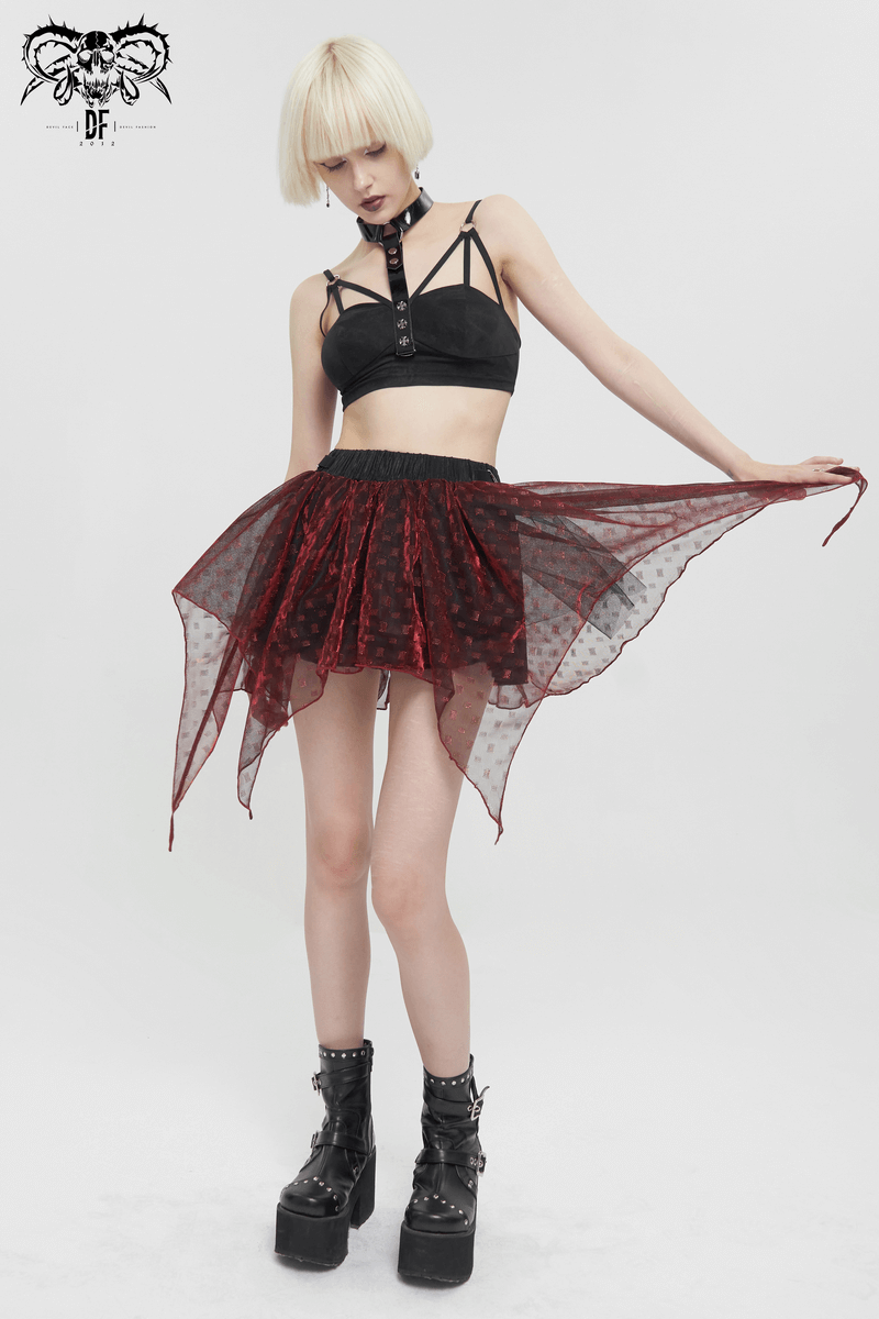 Woman in grunge style with wine red layered mesh skirt and black crop top, showcasing a playful, edgy fashion look.