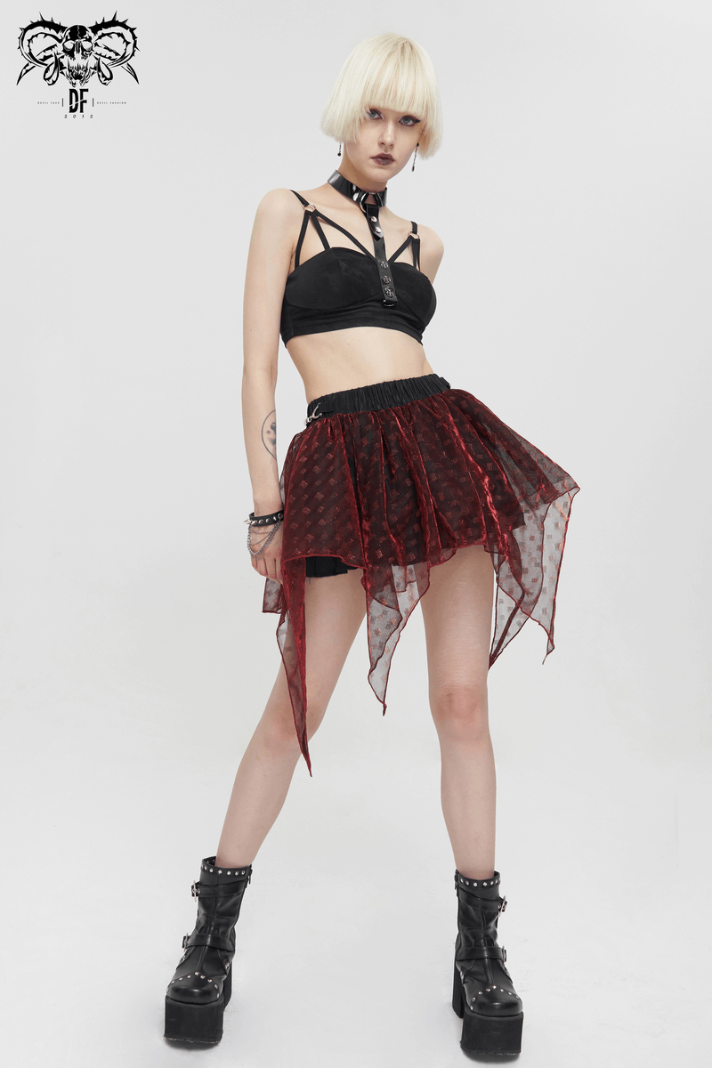 Stylish woman in a grunge-inspired wine red layered mesh skirt and edgy top, showcasing a bold fashion statement.