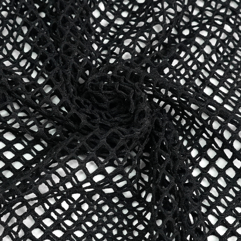 Close-up of black elastic mesh fabric, perfect for punk-style bodysuits and edgy fashion looks.