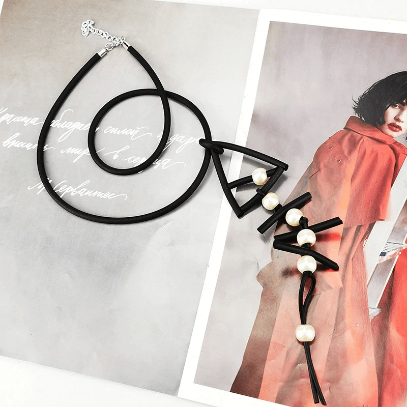 Gothic rubber fish bone pendant necklace with pearl accents, perfect for unique women's fashion and accessories.