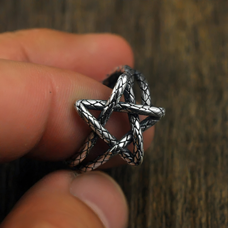 Close-up of a Five Star Open Retro Ring made from 925 sterling silver, held between fingers for a stylish look.