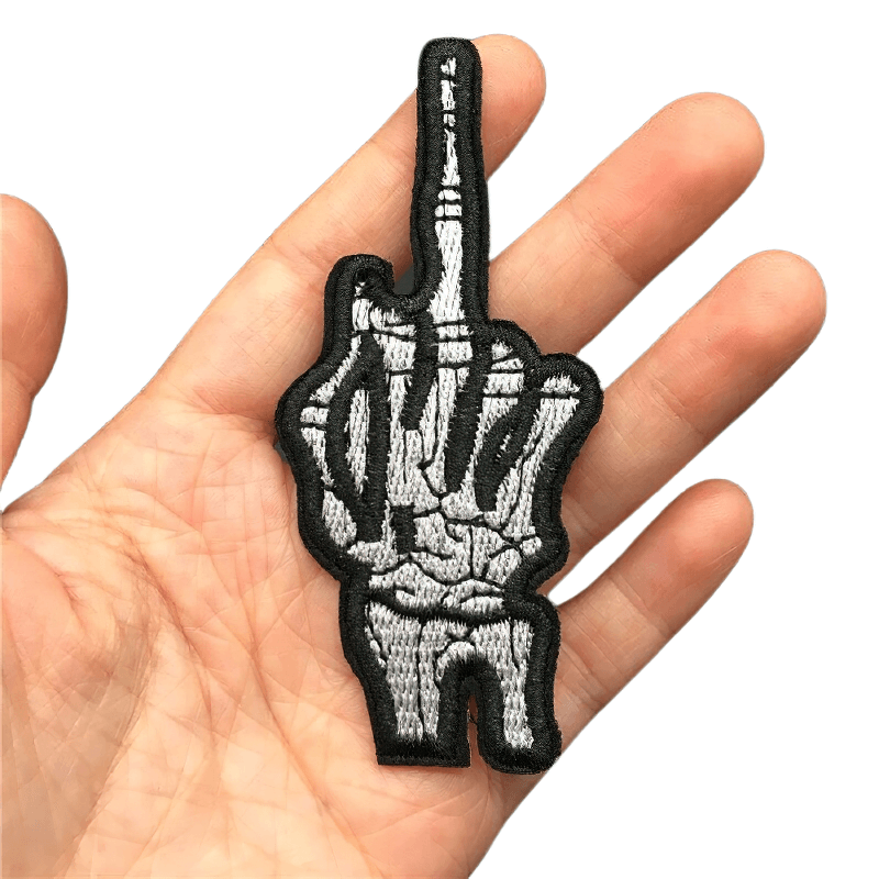 Gothic unisex "Flip Off" bone hand patch held in hand, perfect for alternative fashion and clothing decor.