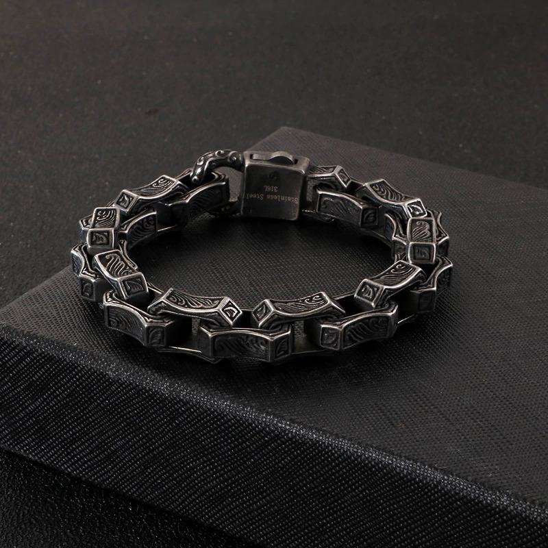 Men's vintage stainless steel cuff bracelet with unique engravings, perfect for punk style outfits.